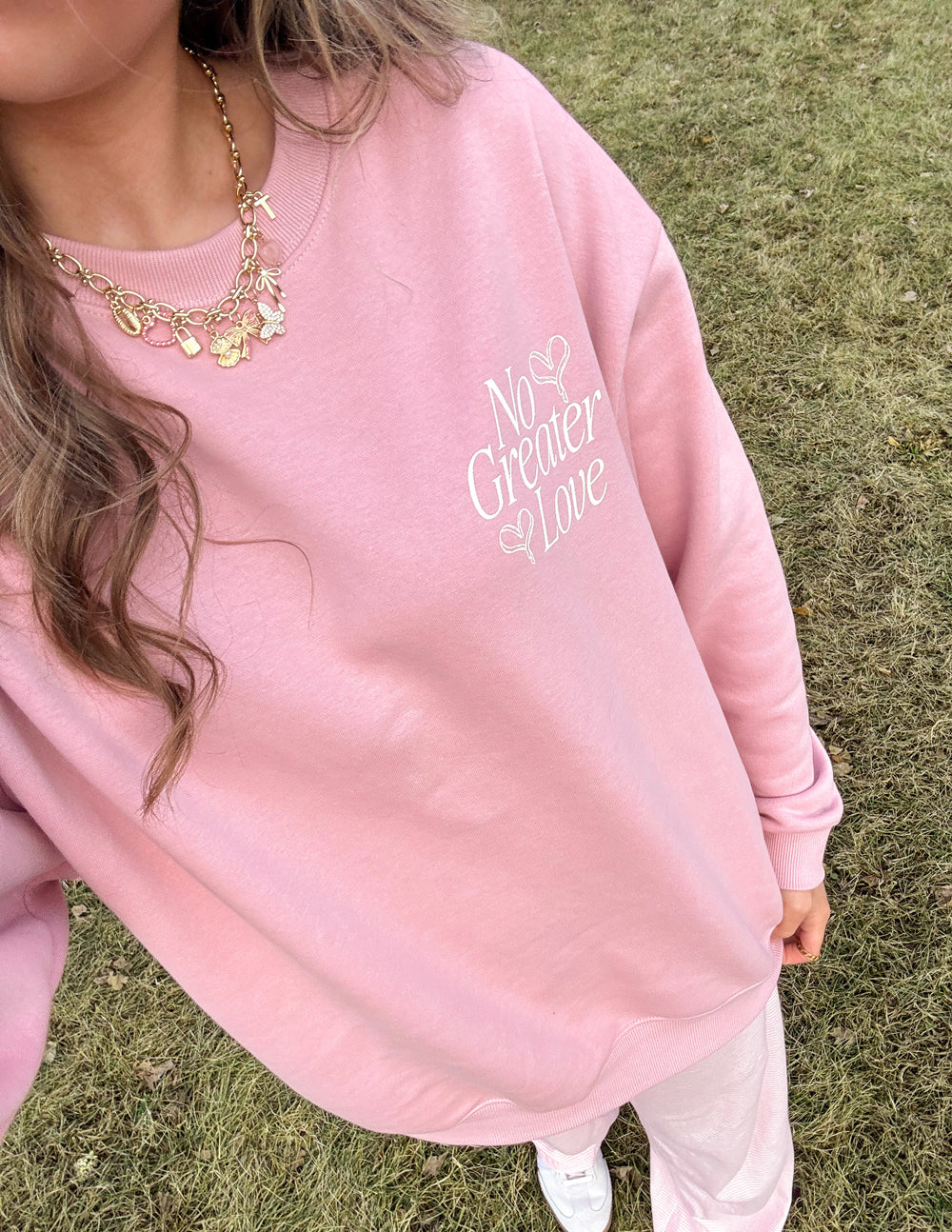 Unisex crewneck sweatshirt in pale pink with small front graphic