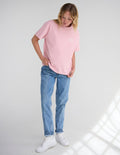 Unisex pink T-shirt with small chest graphic, short sleeves and crew neck.