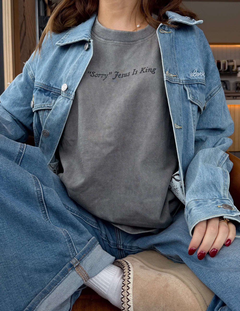 Gray T-shirt with 'Jesus Is King' front print under denim jacket, crew neck.