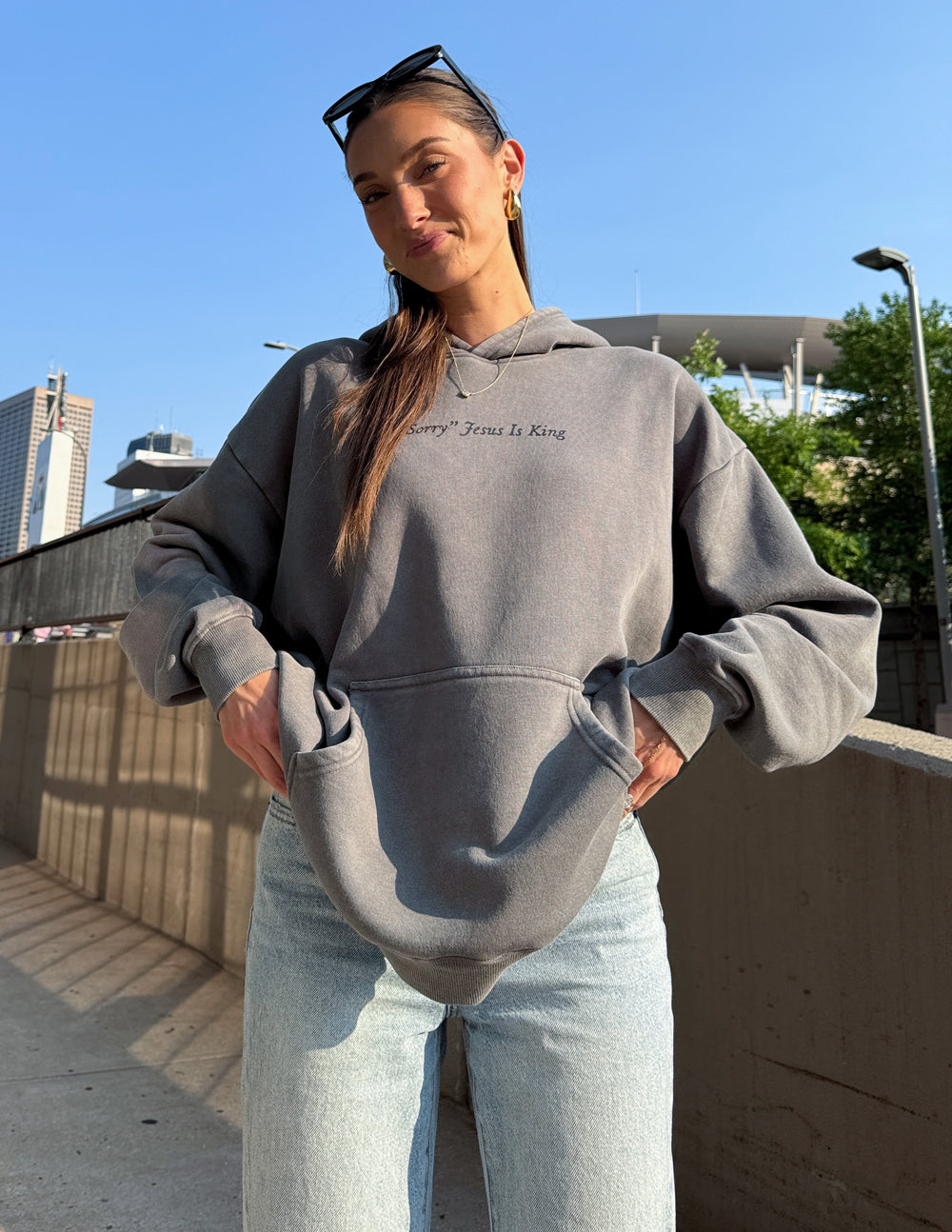 Gray unisex pullover hoodie with front pocket and small “Jesus Is King” script logo