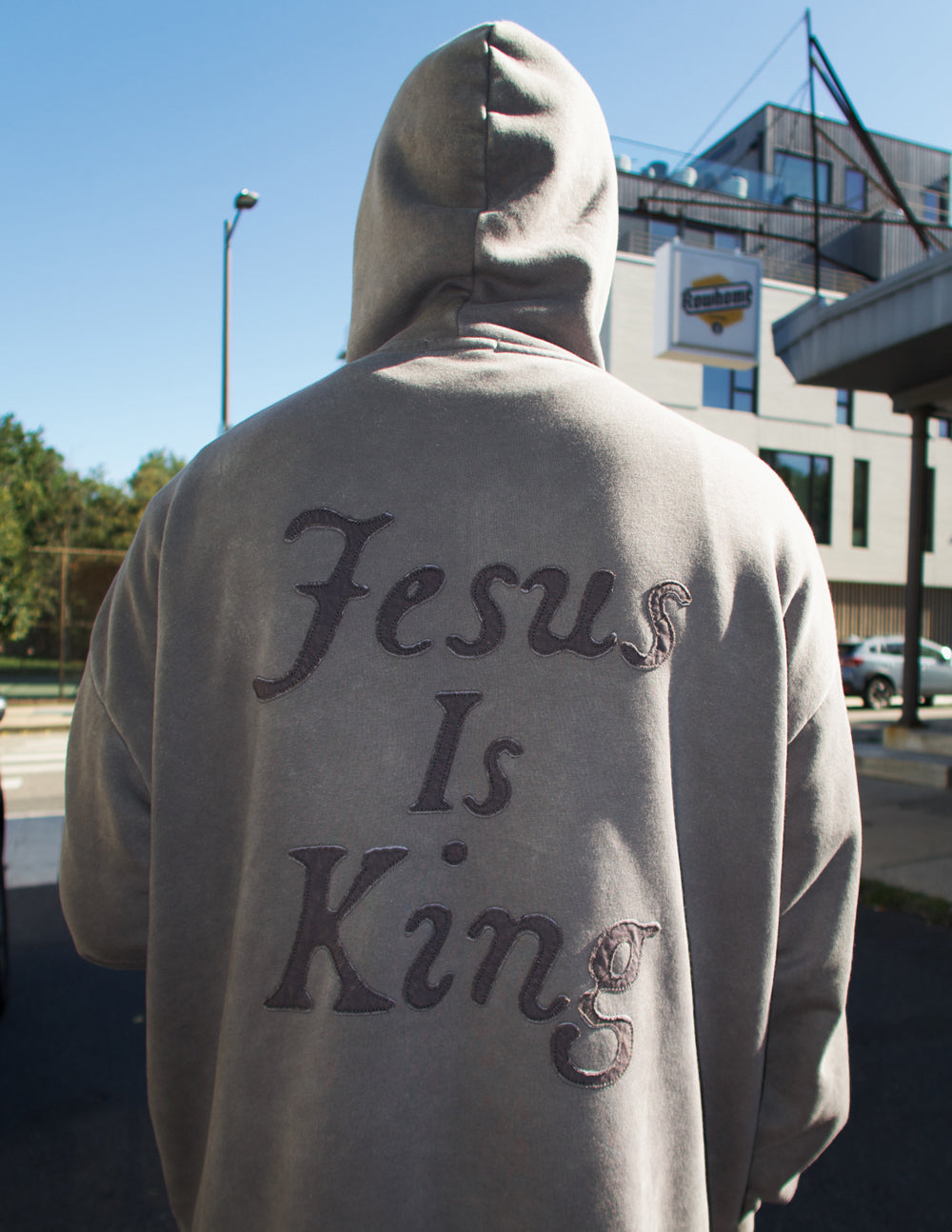Gray unisex hoodie with large back script “Jesus Is King” design