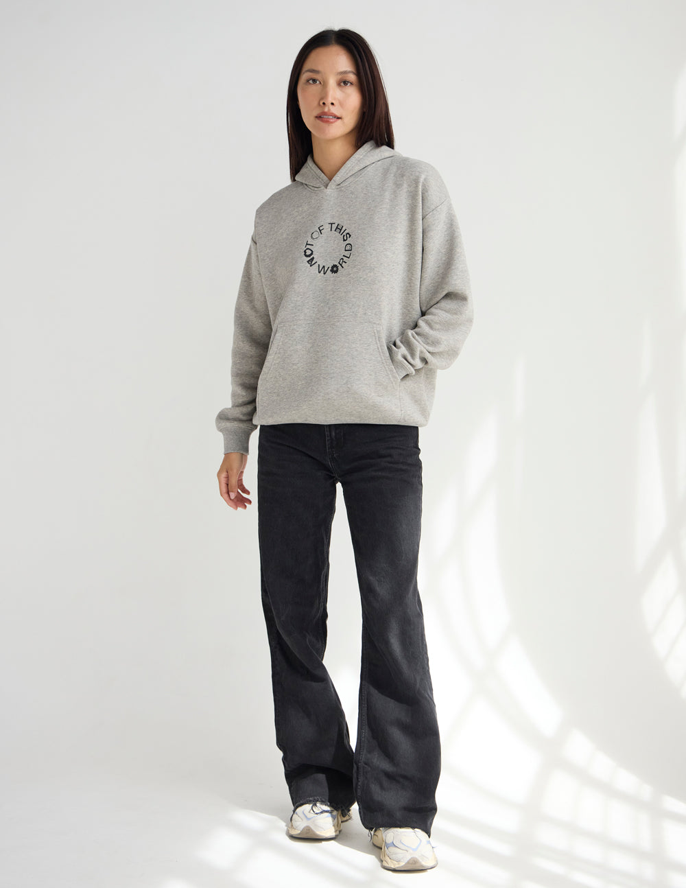 Light beige unisex hoodie with hood, small circular chest logo, long sleeves