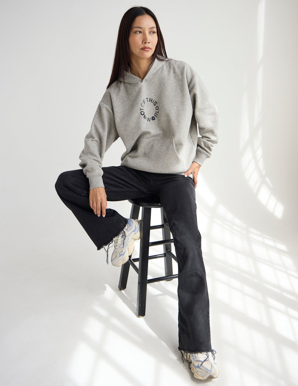 Light beige unisex hoodie with hood and front circular logo, relaxed fit