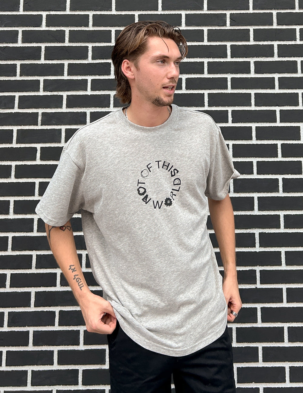 Unisex heather gray graphic T-shirt with crew neck and front text logo