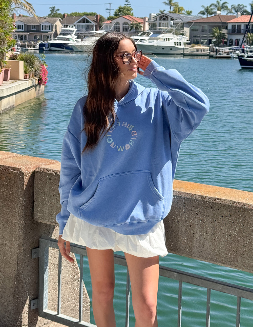 Blue unisex pullover hoodie with front logo graphic and hood
