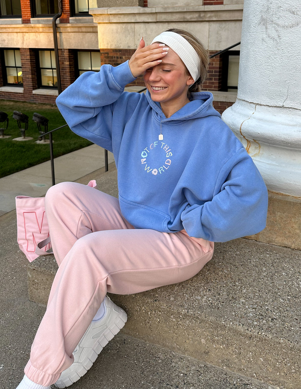 Blue unisex pullover hoodie with hood and front logo graphic