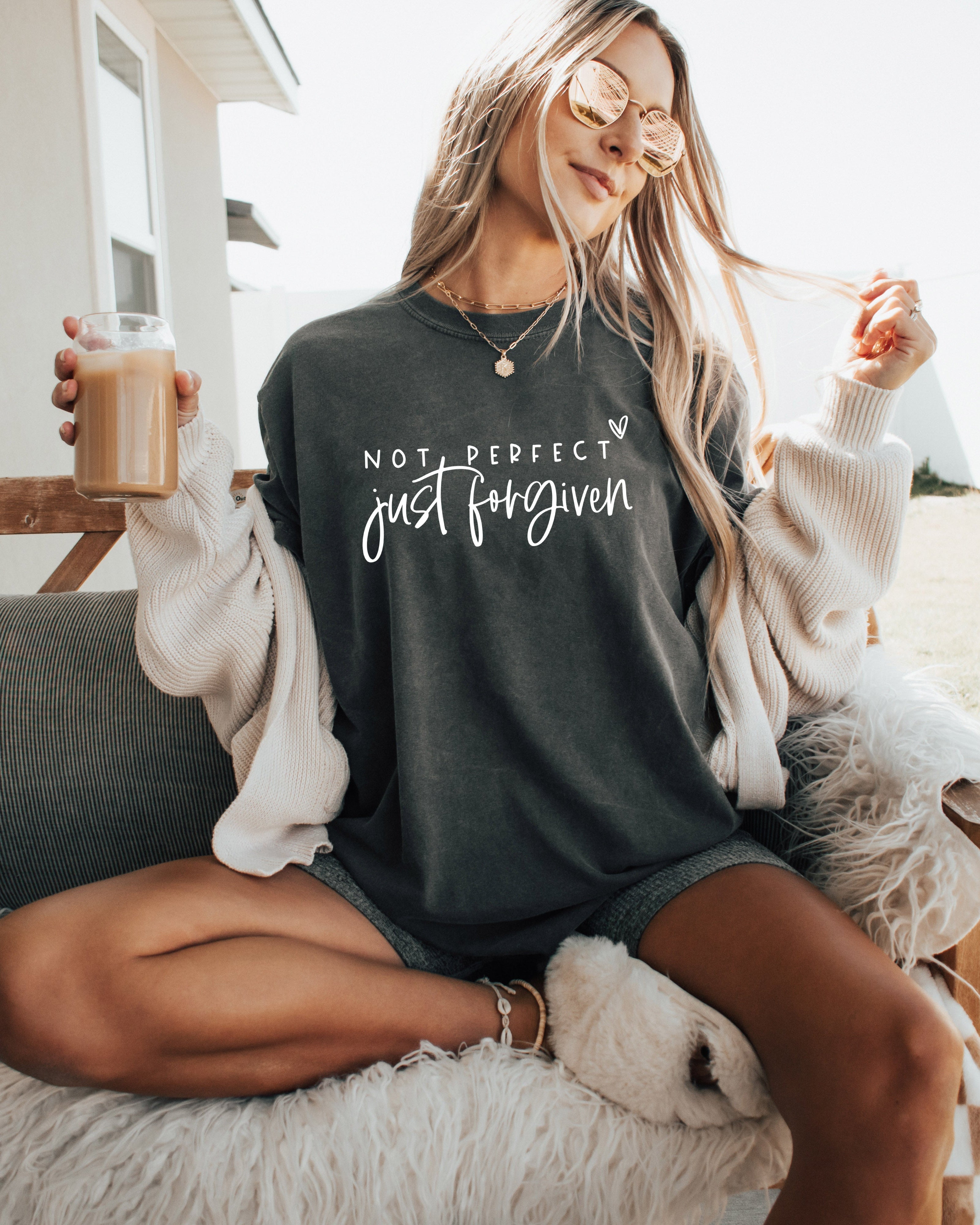 Black garment-dyed T-shirt with “Not perfect, just forgiven” graphic