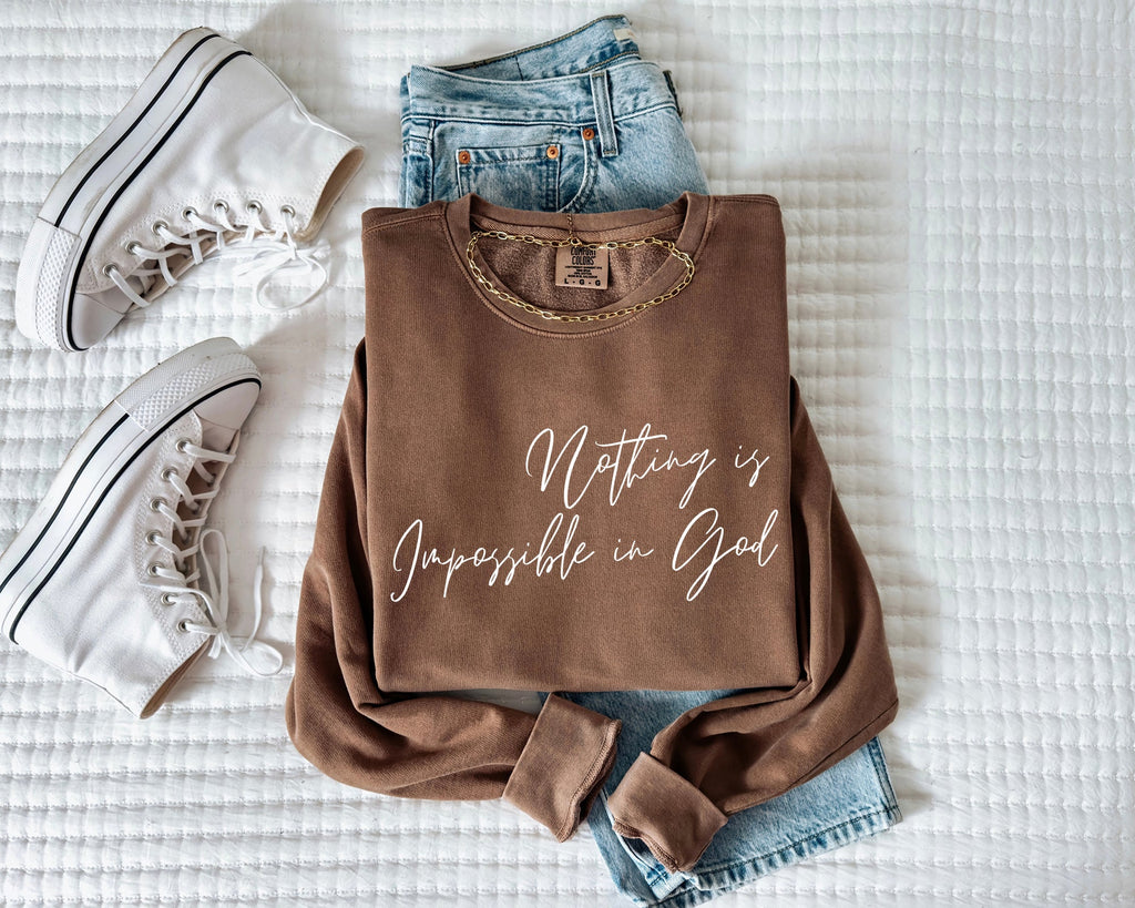 Dyed unisex crewneck sweatshirt in dark brown with white inspirational front text