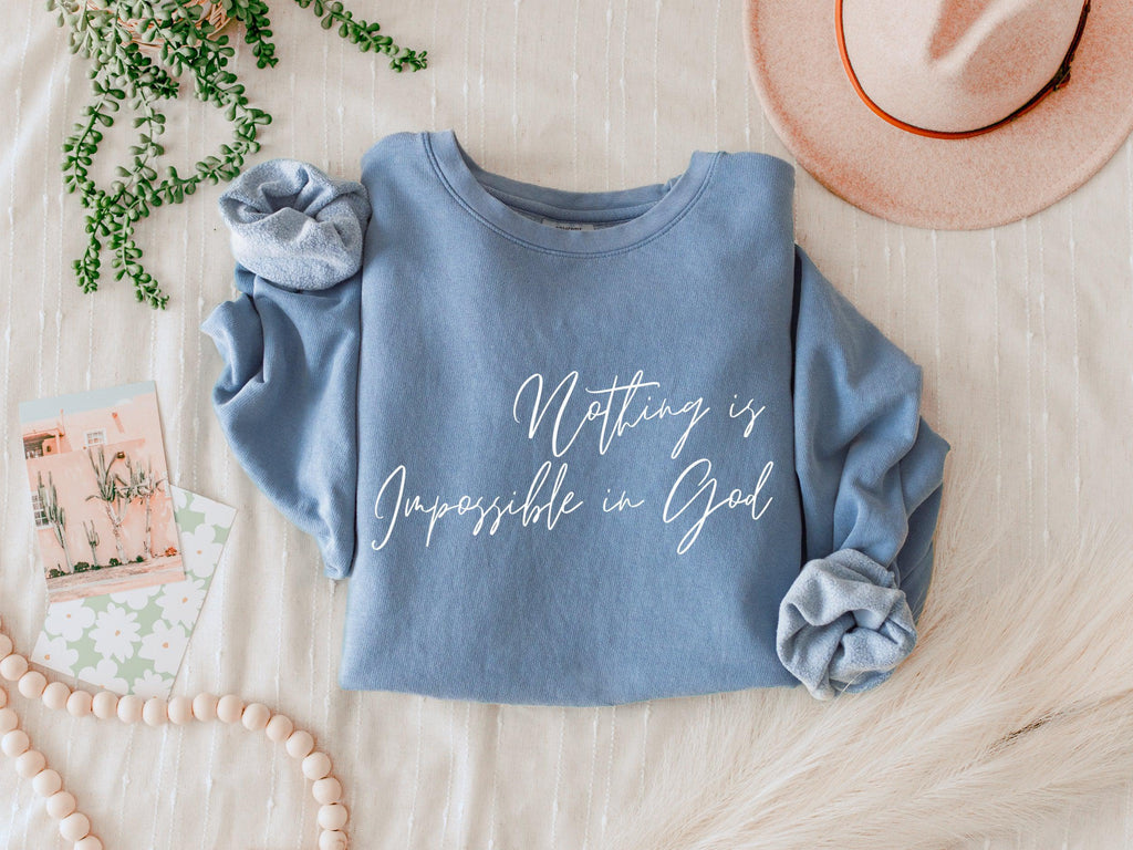 Blue crewneck sweatshirt with white inspirational front print and gathered sleeve details