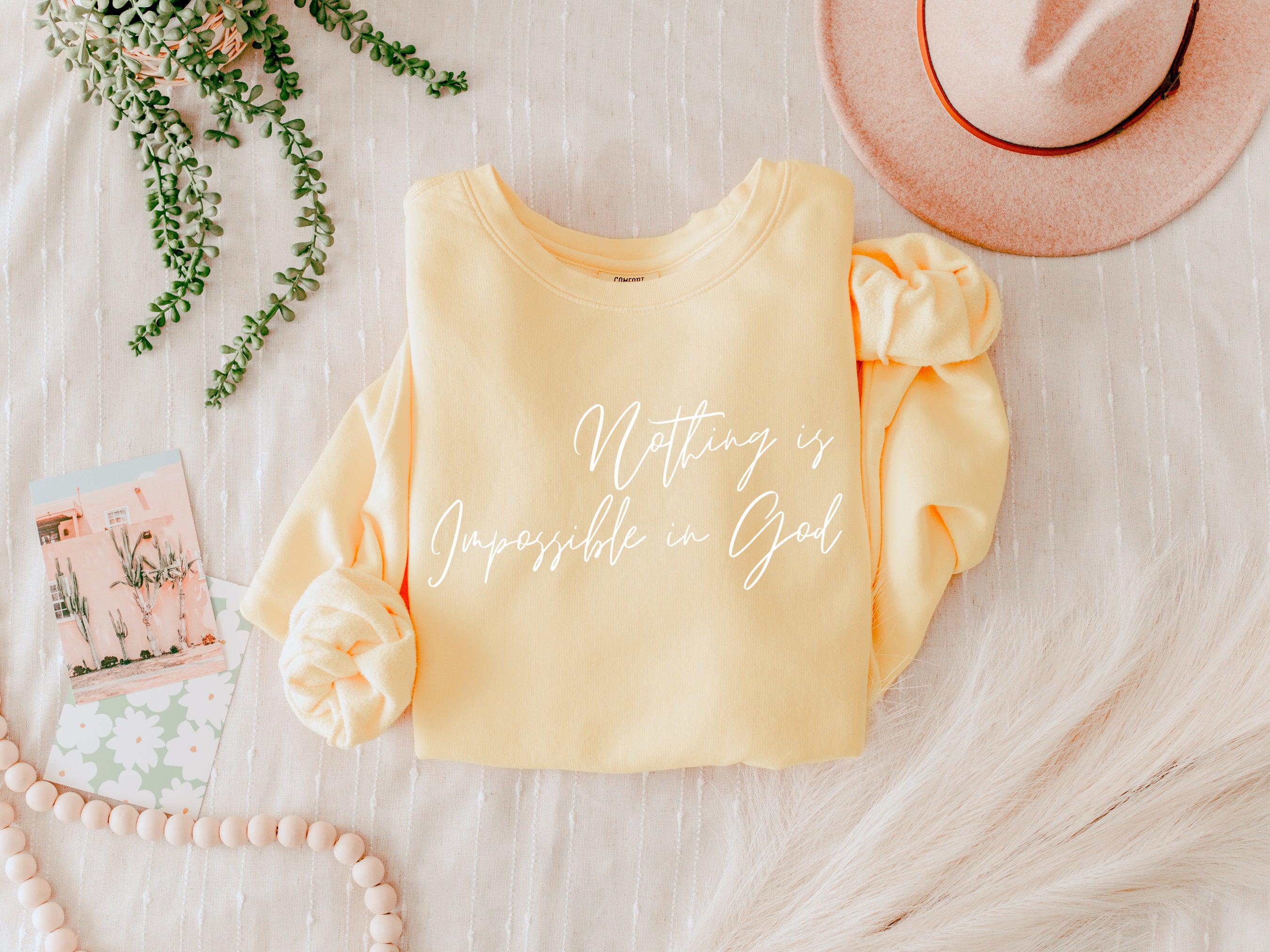 Light yellow crewneck sweatshirt with white inspirational front print and gathered sleeve details