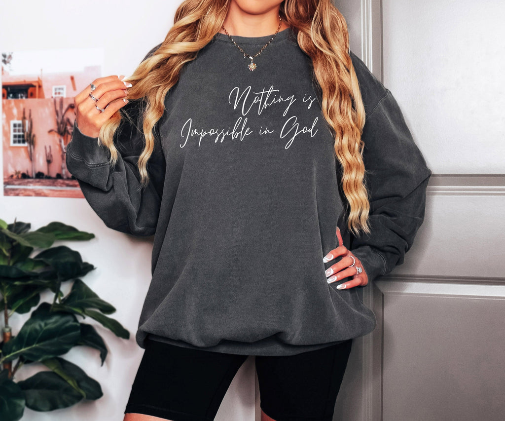 Dark crewneck sweatshirt with long sleeves and white Christian-style slogan print