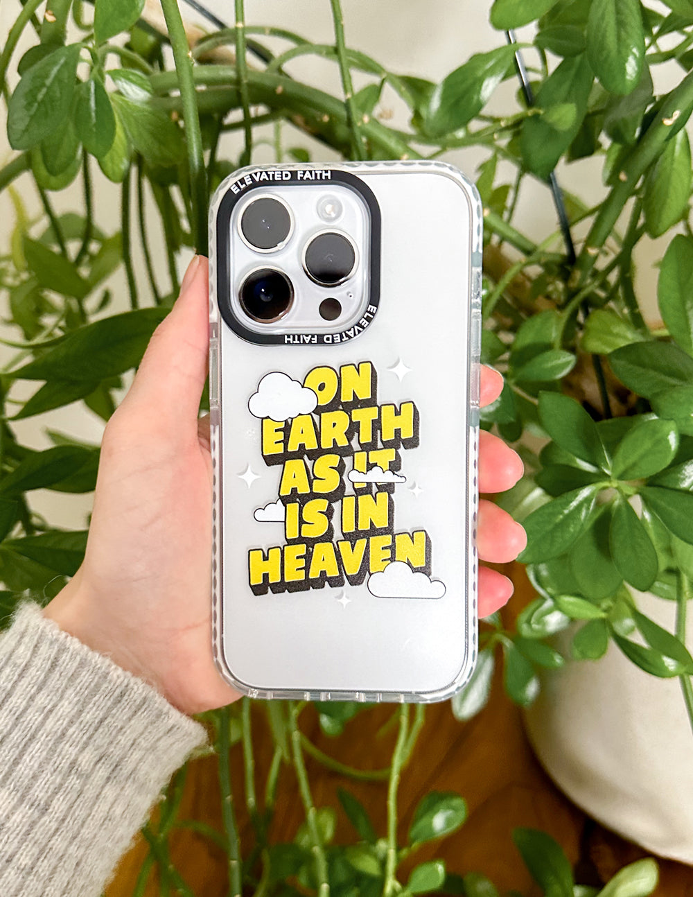 Clear phone case with yellow text graphic, cloud icons, and star details