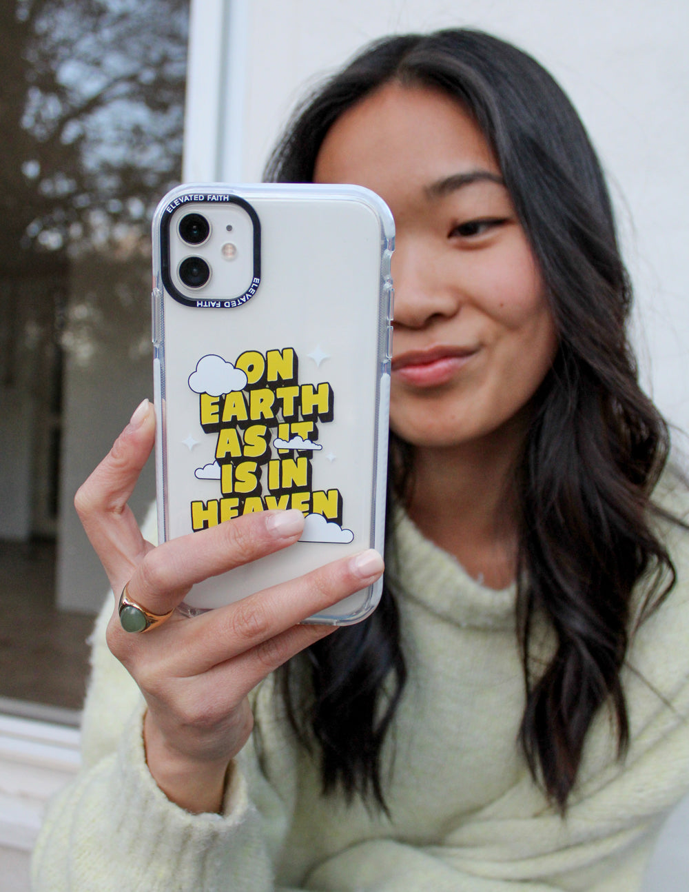 Clear phone case with yellow and green text graphic and cloud icons