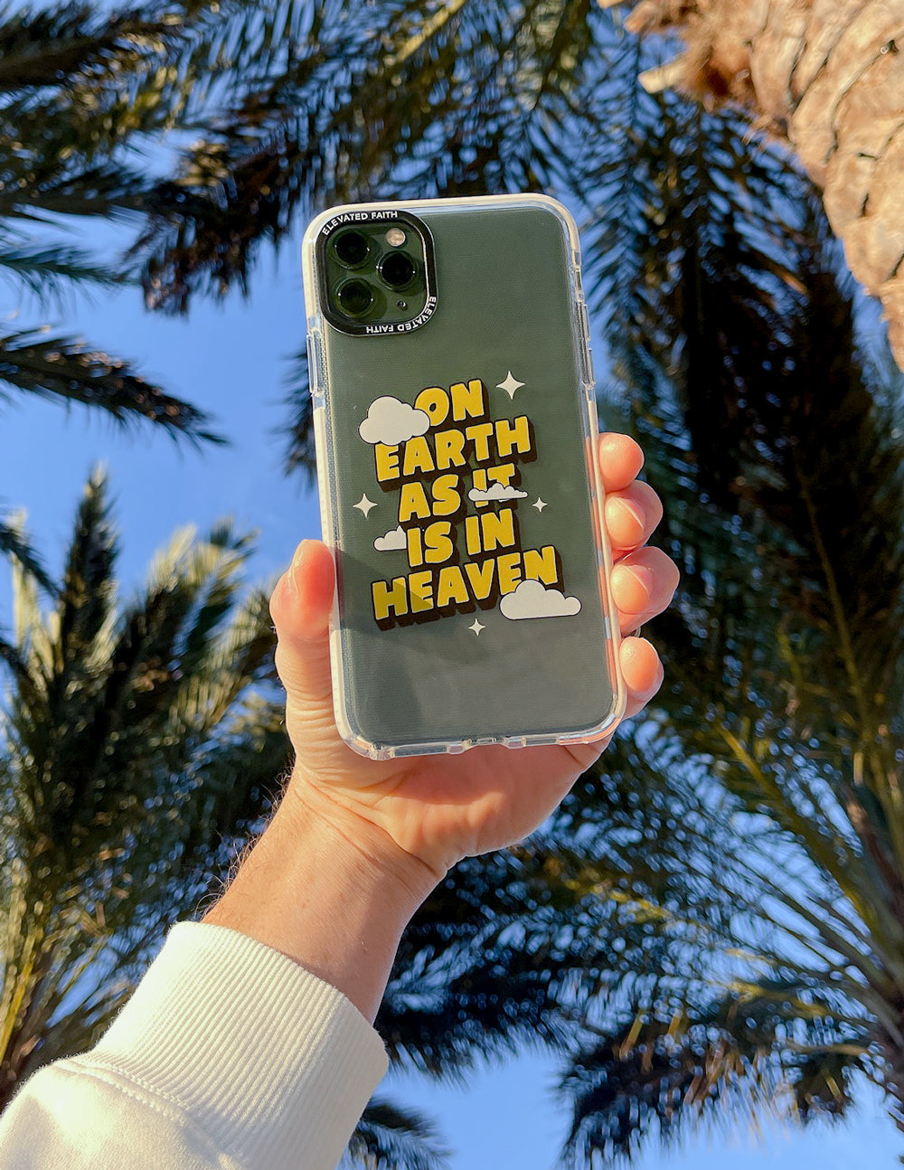 Transparent phone case with yellow text graphic and cloud icons on dark green