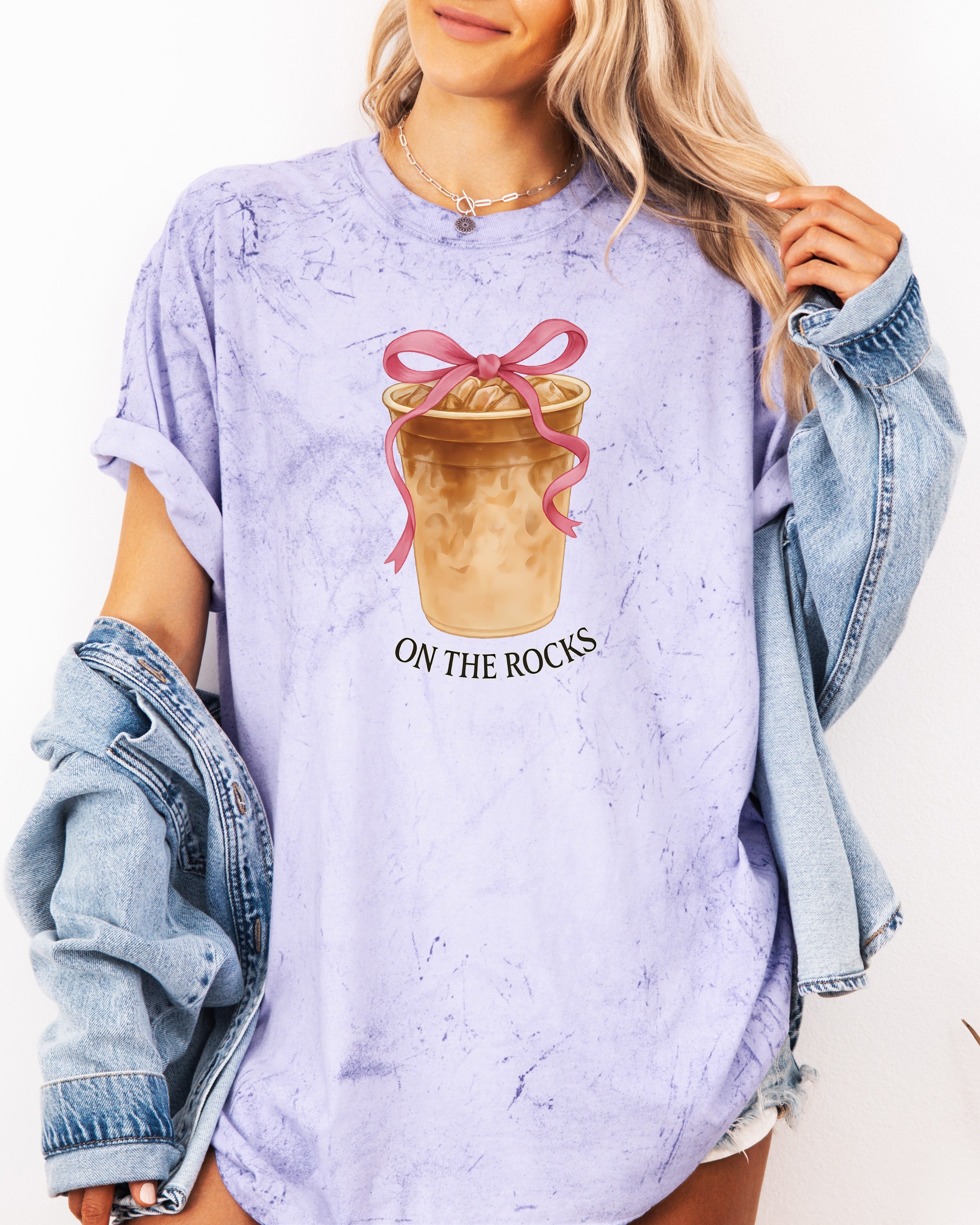 Lavender iced latte graphic T-shirt with “ON THE ROCKS” text under ribboned drink