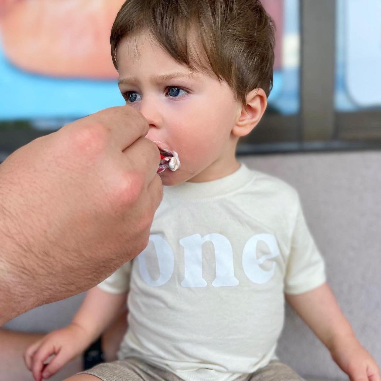 White baby T-shirt with “one” serif print, short sleeves