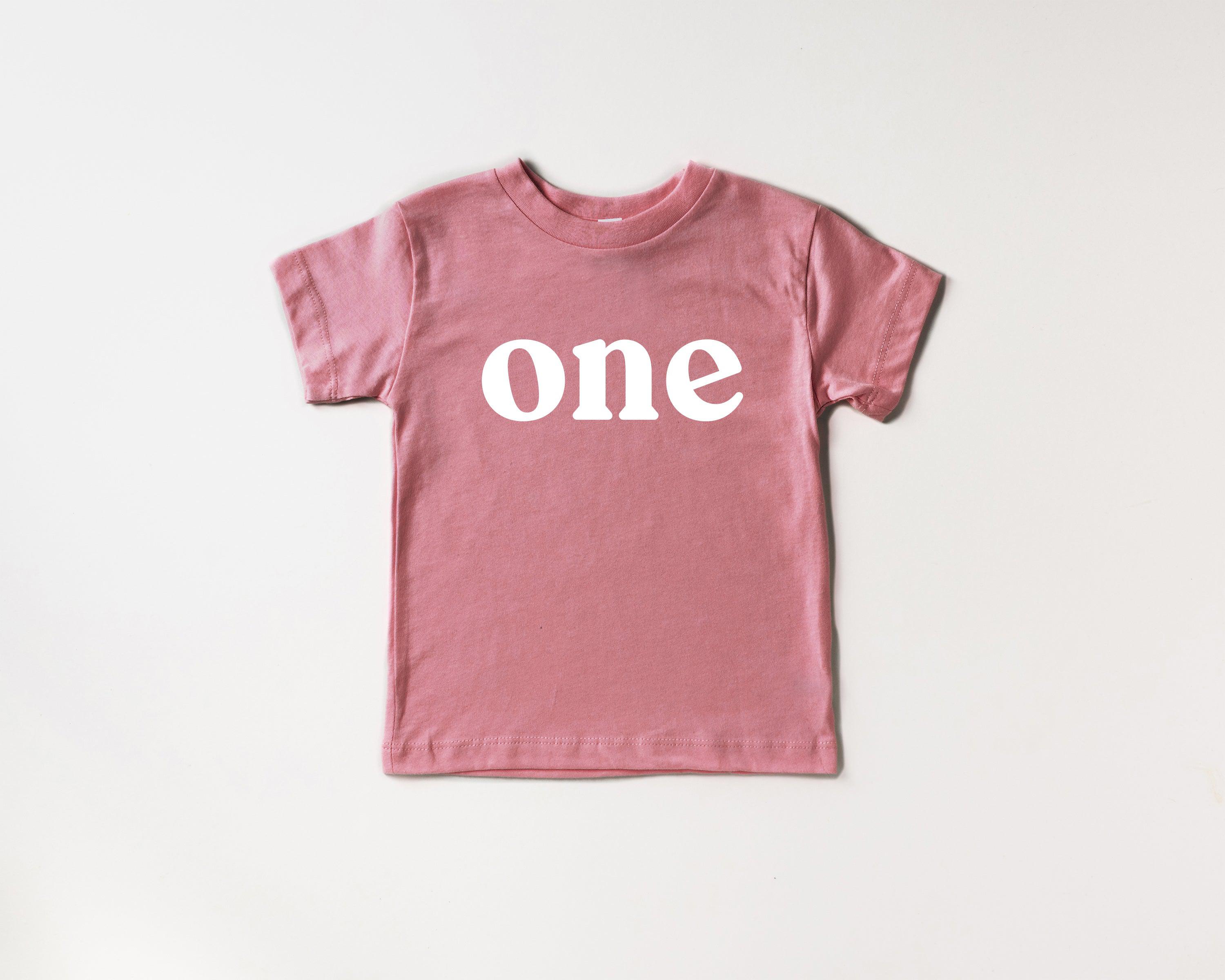 Rose pink kids organic cotton tee with 'one' serif graphic