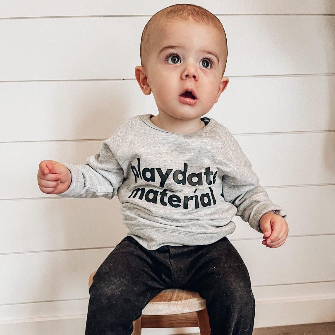 Heather grey toddler crewneck sweatshirt with “playdate material” graphic