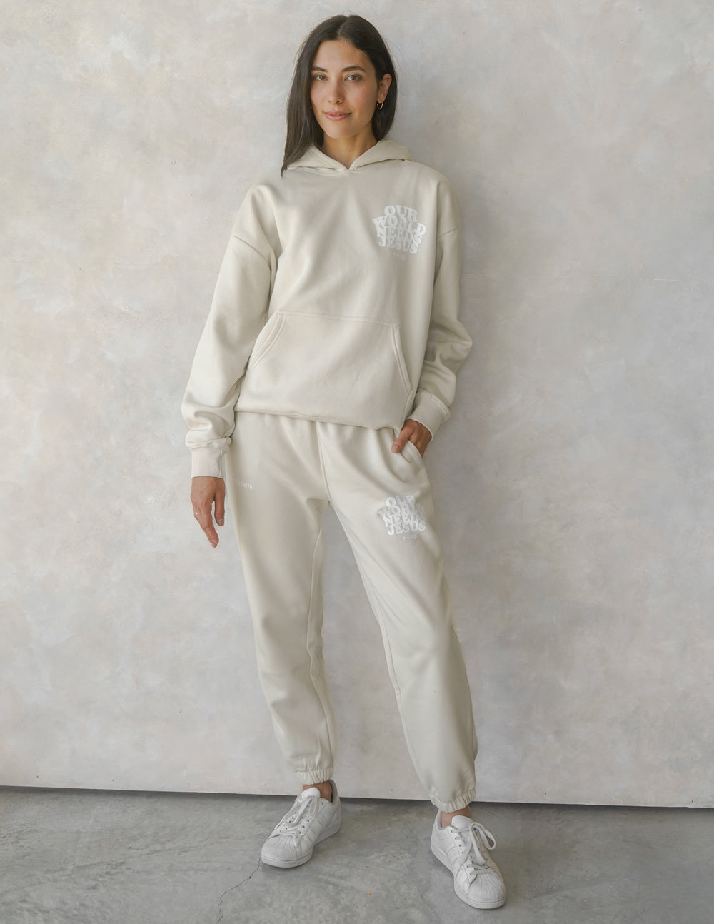 Beige unisex sweatpants with matching logo print, drawstring waistband, relaxed fit