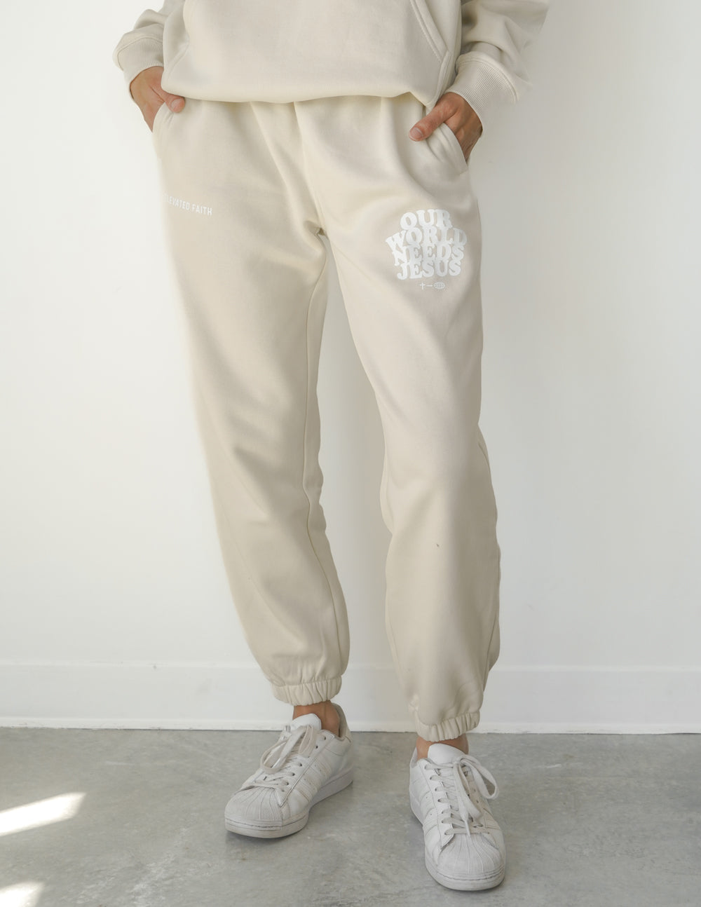 Beige unisex sweatpants with logo print and elastic ankle cuffs
