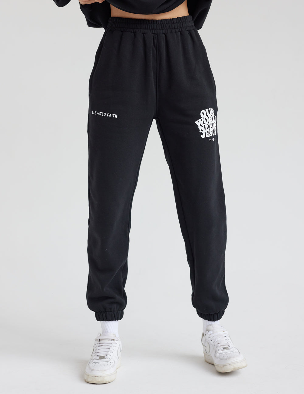 Black sweatpants with limited edition text and Our World Needs Jesus logo