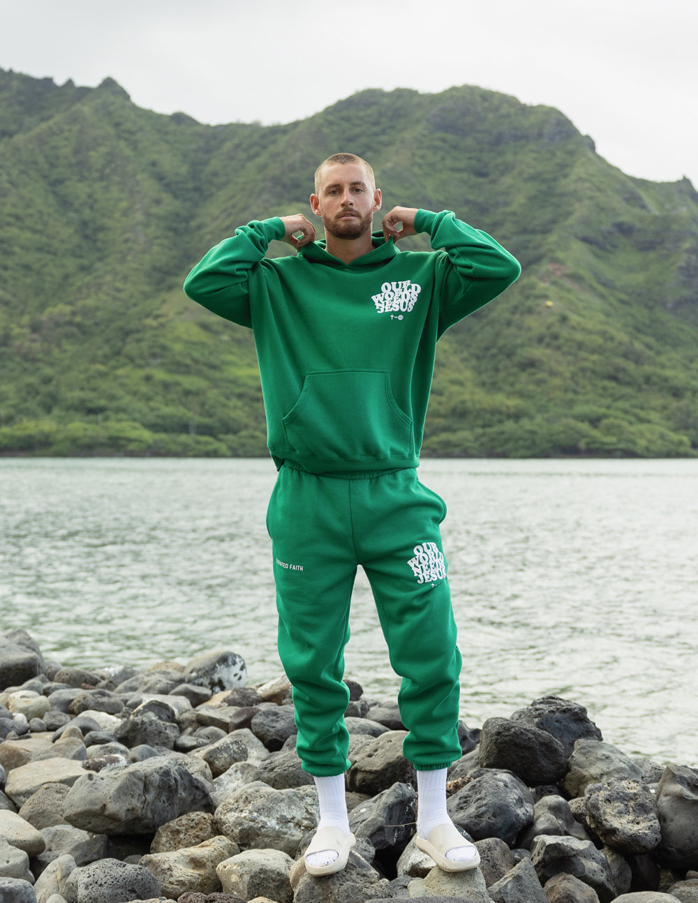 Green unisex hoodie and joggers with matching white logo graphic