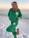 Green unisex hoodie with white chest graphic and front pouch pocket