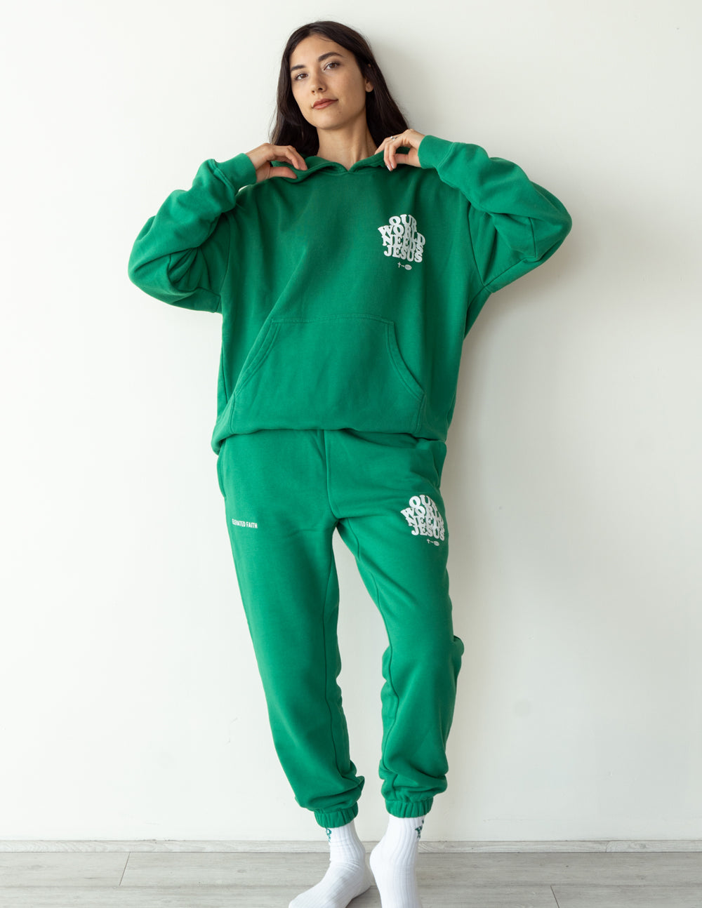 Green unisex sweatpants with logo print on left thigh and elastic waistband