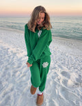 Green unisex sweatpants with printed logo on left thigh