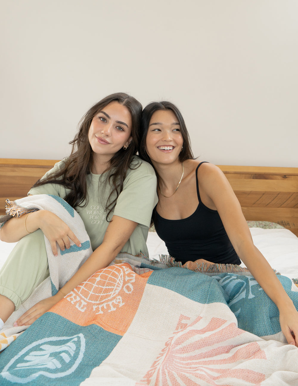 Patchwork throw blanket in pastel teal and orange patchwork, printed motifs, fringed edge