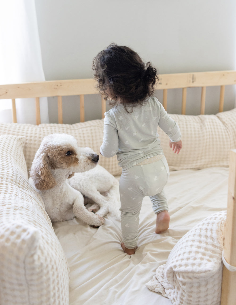 Kids bamboo pajama set back view on child: light cream long-sleeve top and joggers