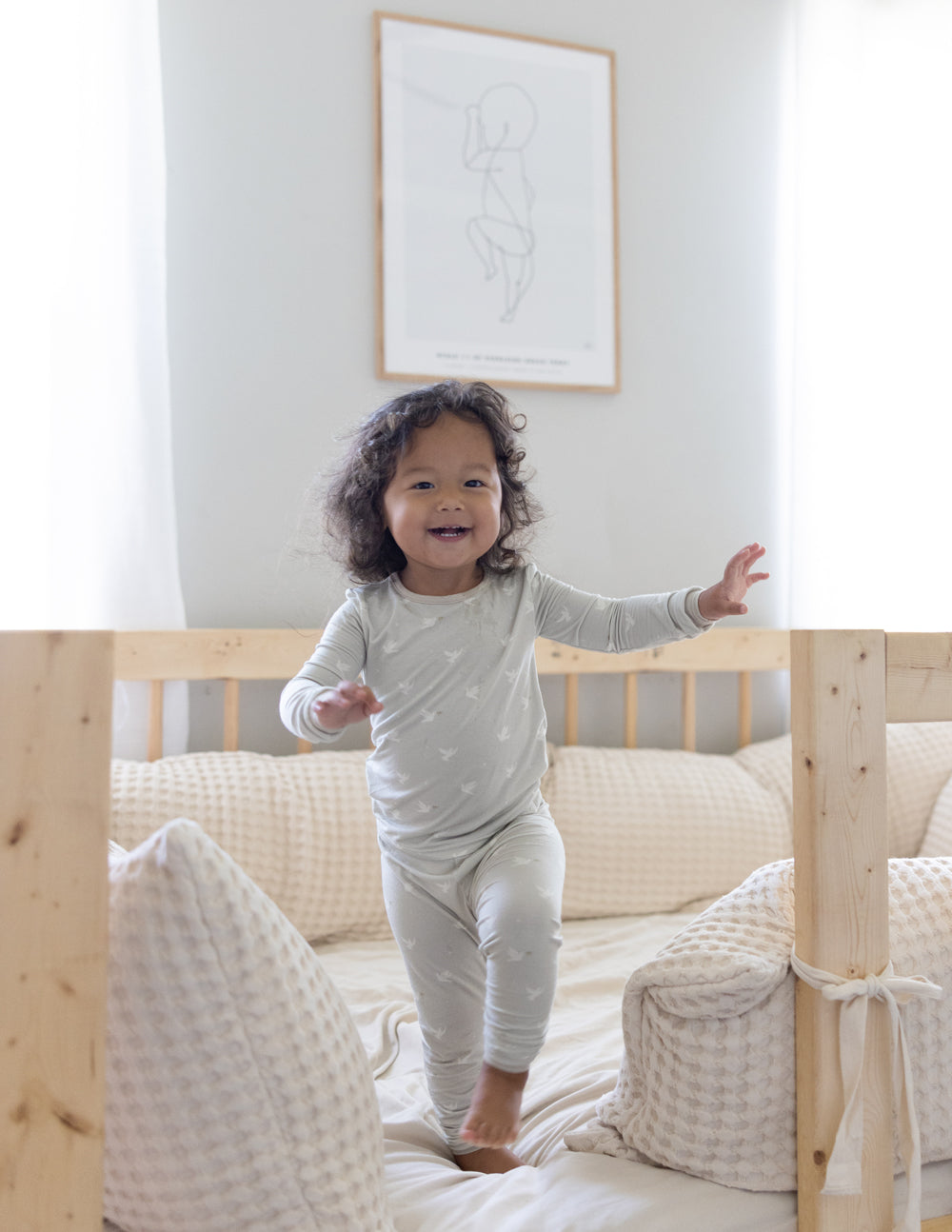Kids bamboo pajama set on child with long-sleeve top and jogger pants, light cream
