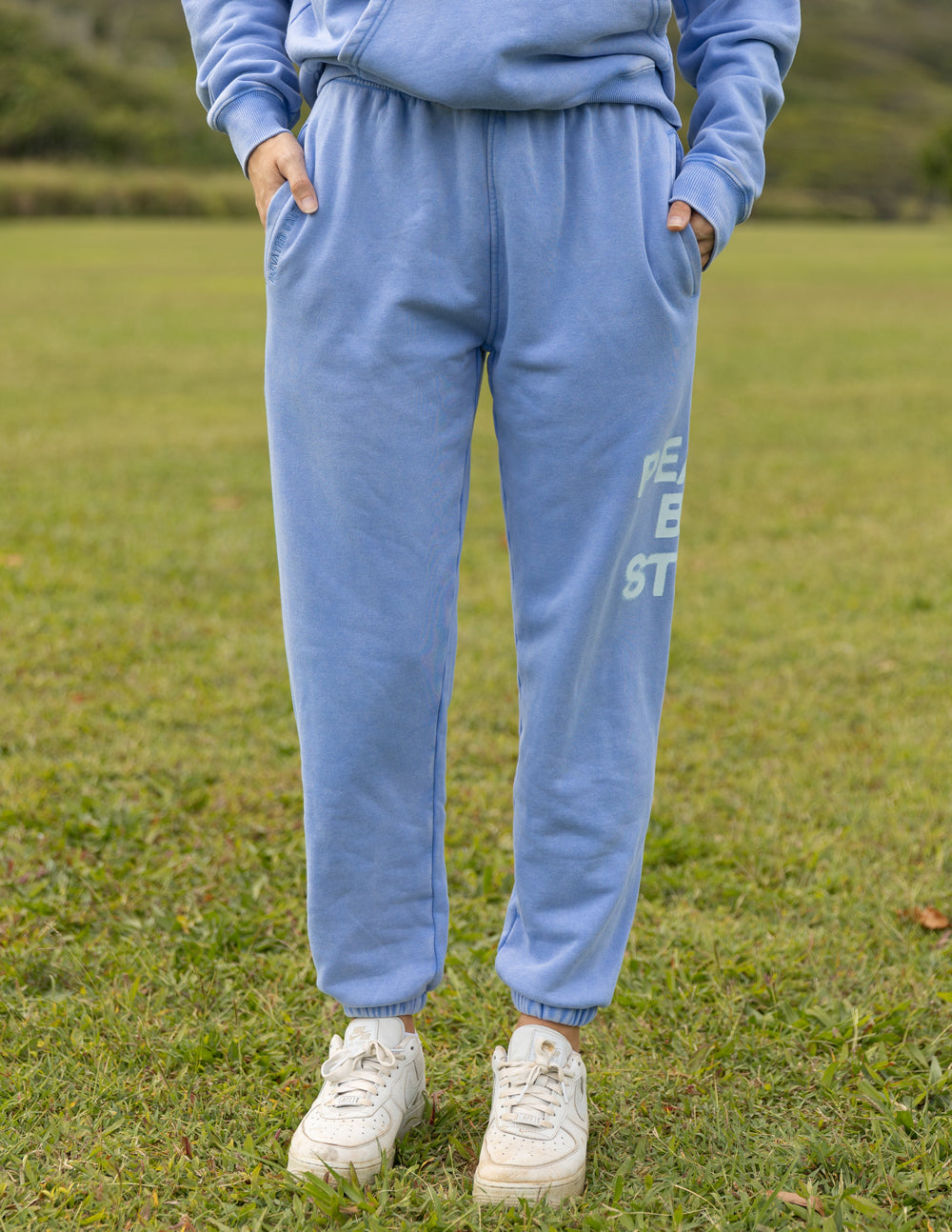 Light blue unisex sweatpants with elastic waistband and cuffed ankles