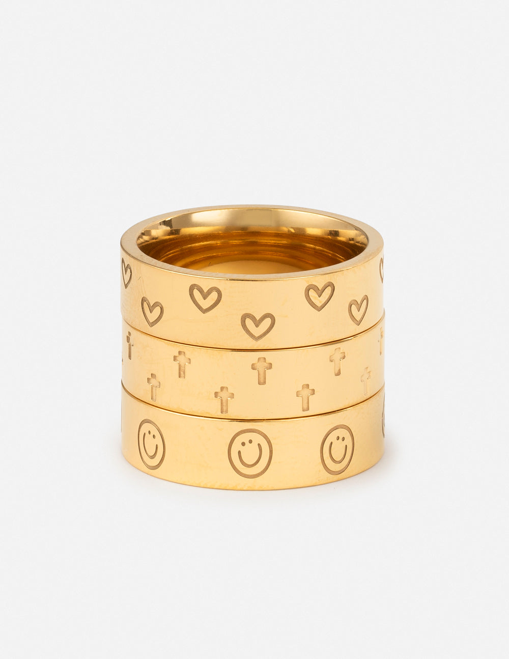 Gold-tone engraved ring set with heart and cross motifs, two stacked bands