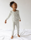 Kids bamboo pajama set with long-sleeve top and jogger pants, light cream print