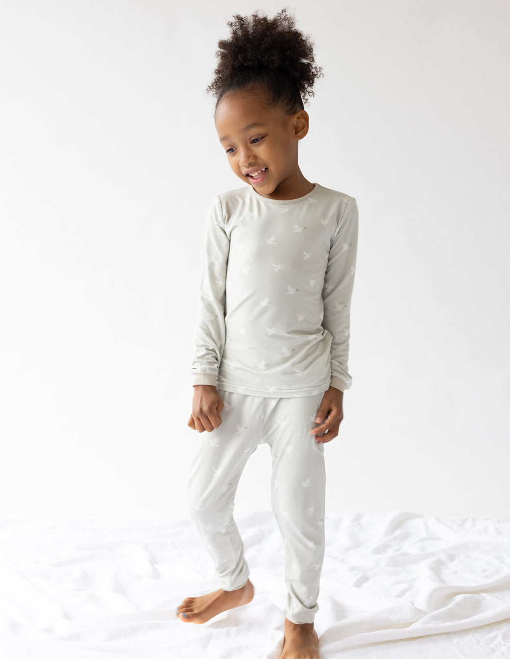 Kids bamboo pajama set full-body view: long-sleeve top and jogger pants, light cream