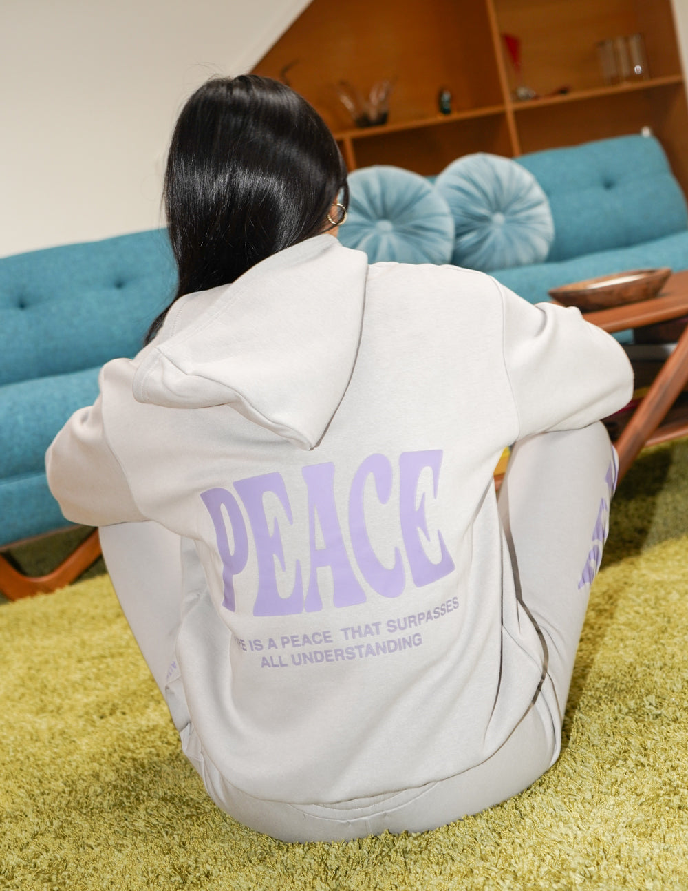 Light gray unisex hoodie with purple "PEACE" print on back, hood, and pouch pocket.