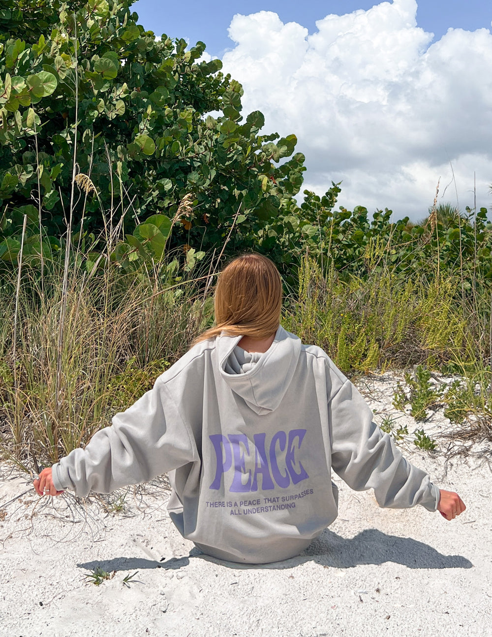 Light gray unisex hoodie, back view, with purple "PEACE" graphic and hood.