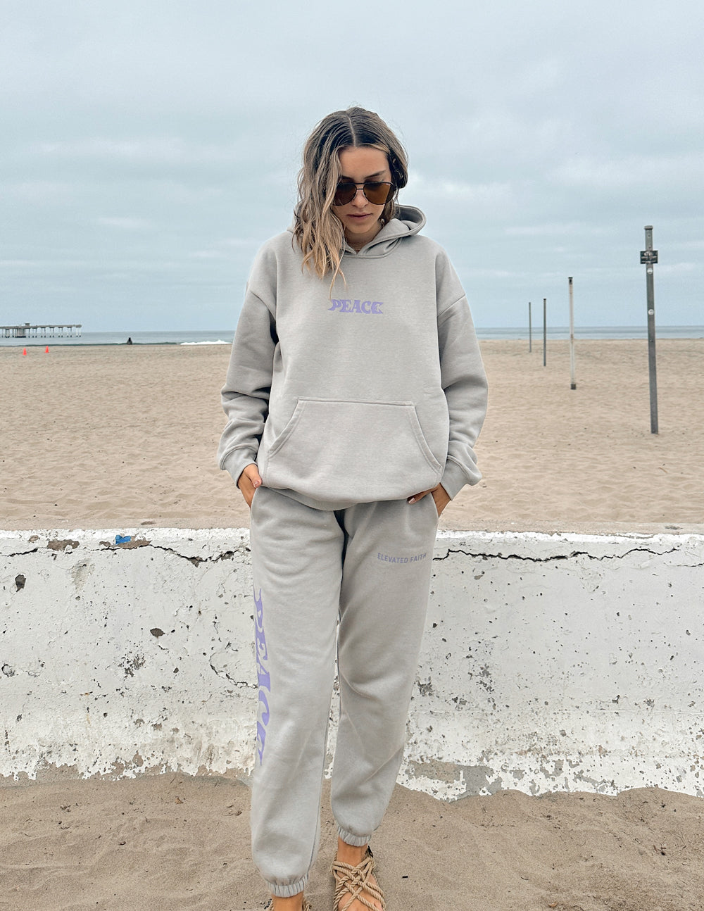 Unisex sweatpants, light gray with purple Peace logo print, front view