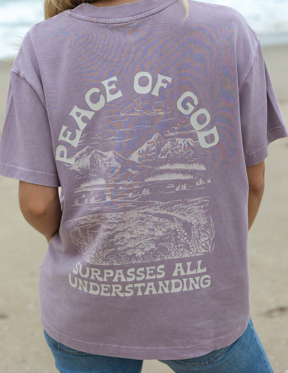 Lavender unisex T-shirt close-up of back graphic and "Surpasses all understanding" text