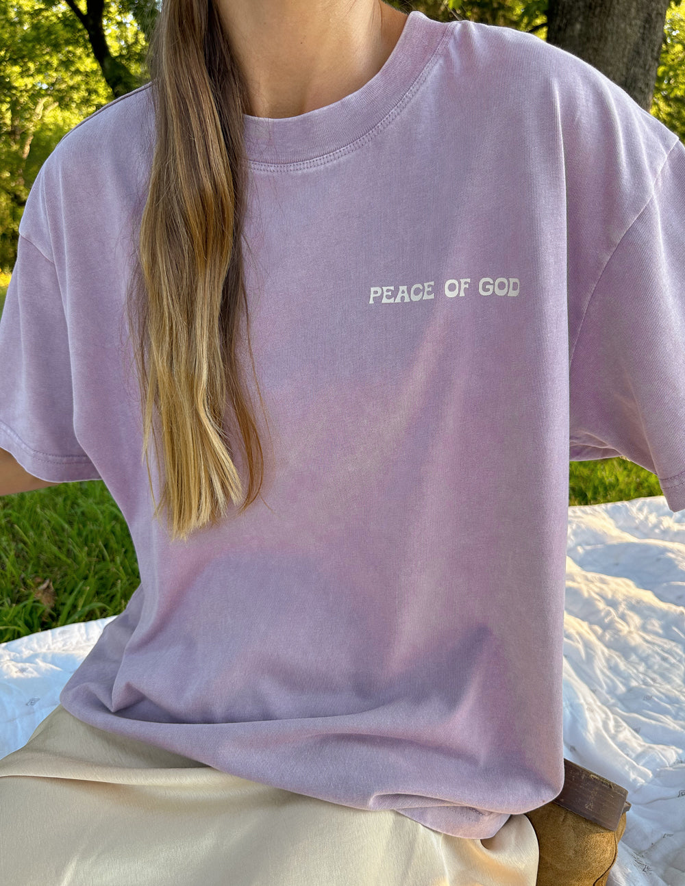 Lavender unisex T-shirt chest view with small "PEACE OF GOD" text