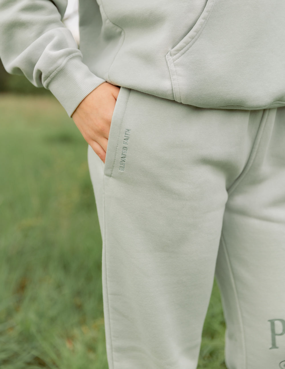Mint unisex sweatpants close-up with side seam pocket and “Perfect Love” print