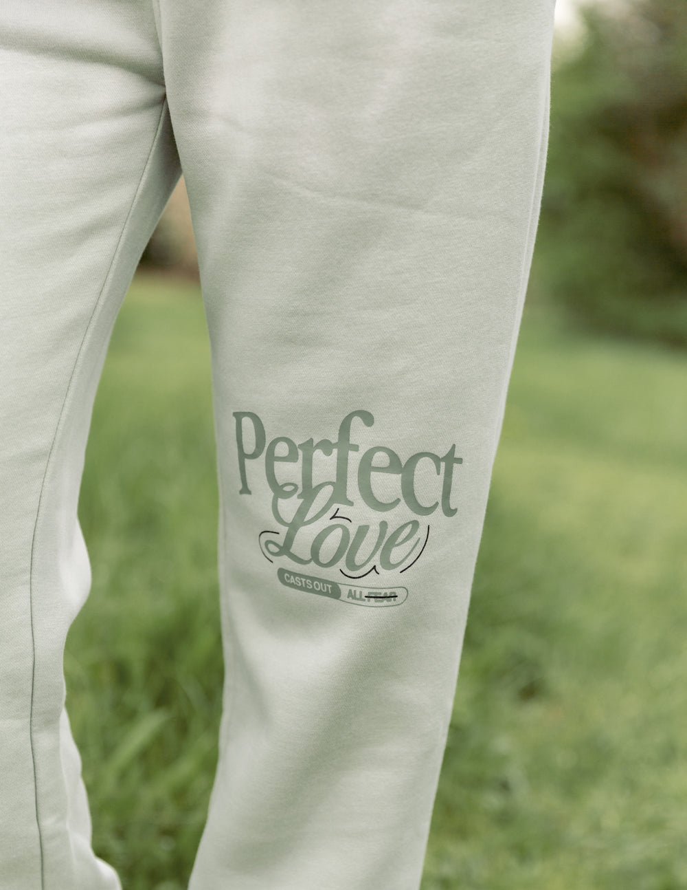 Mint unisex sweatpants leg with “Perfect Love” graphic and knit cuff