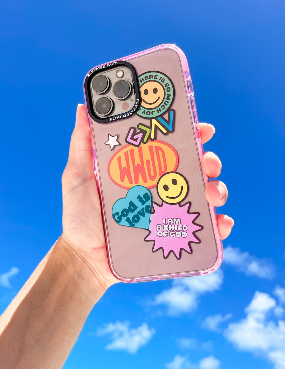 Pink phone case with transparent sticker collage, smiley icons, raised camera cutout