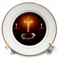 Gold-rimmed porcelain plate with central cross, two lit candles, and clasped hands