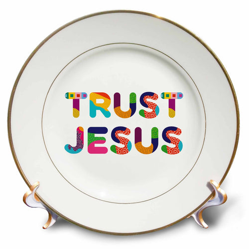 Porcelain plate with gold rim and colorful typography reading “TRUST JESUS”