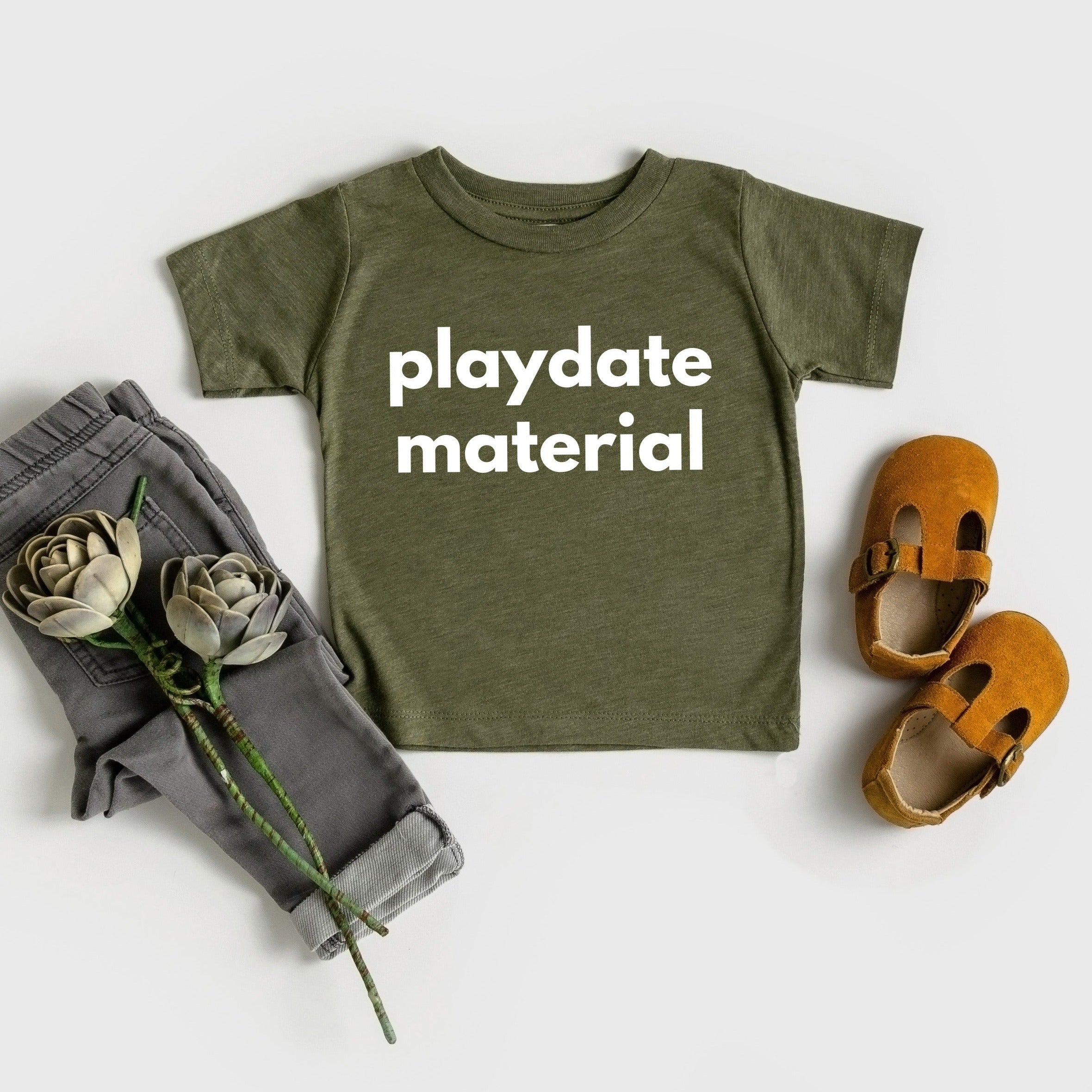 Olive green baby and toddler t-shirt with “playdate material” front print