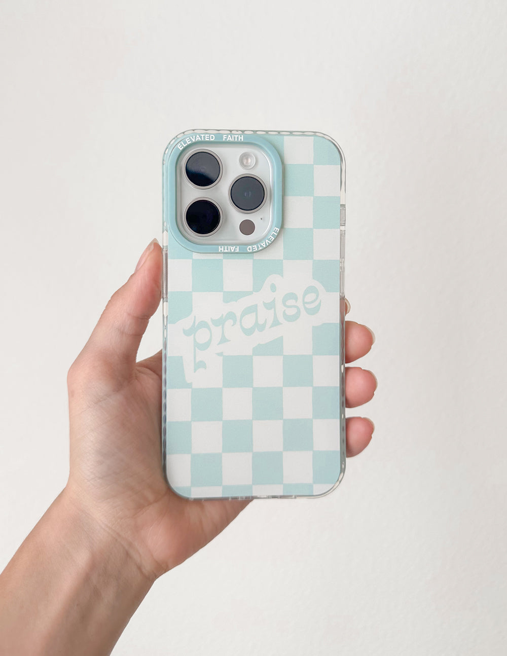 Light blue checkered phone case with multiple camera cutouts and 'praise' text