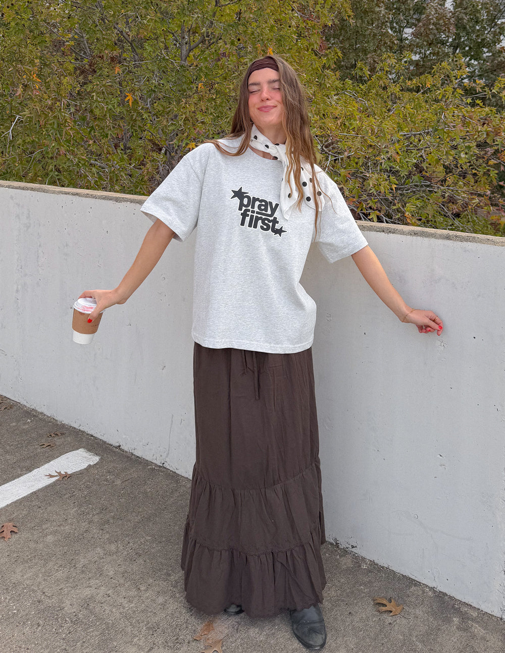 White heavyweight crewneck T-shirt with black “pray first” star logo on the front