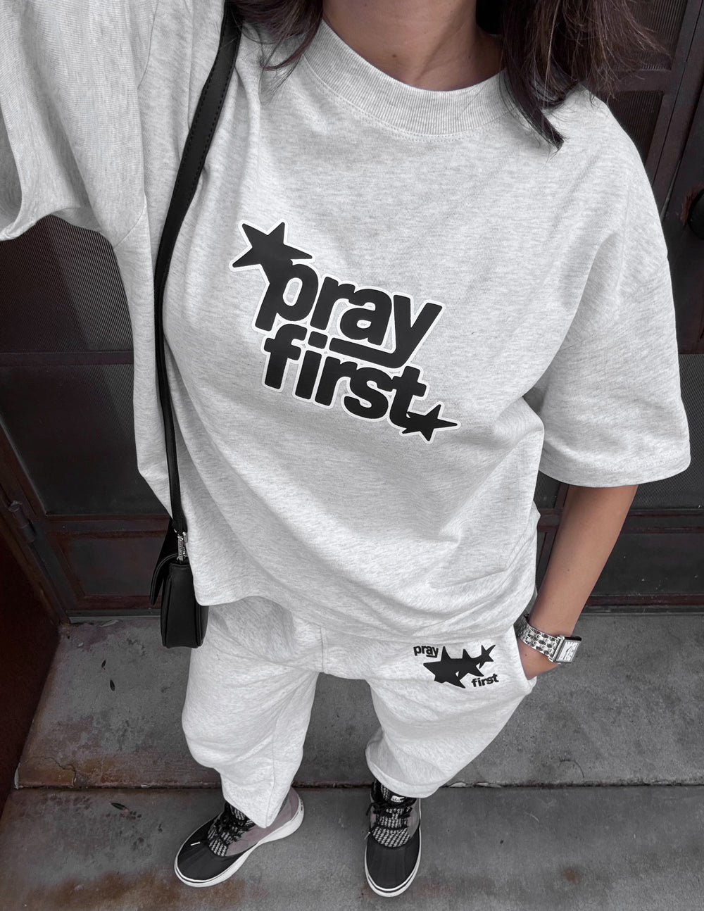 Heather gray heavyweight crewneck T-shirt with black star “pray first” graphic on chest
